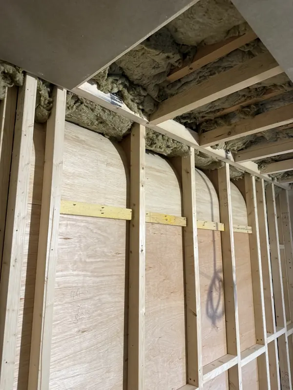 Arched plywood formers set between timber studs