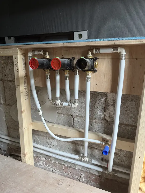 Concealed shower valves and plastic pipework fixed into a timber stud wall