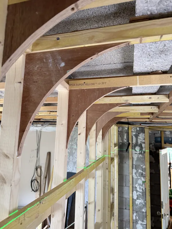 Curved plywood ribs aligned to laser lines during the build