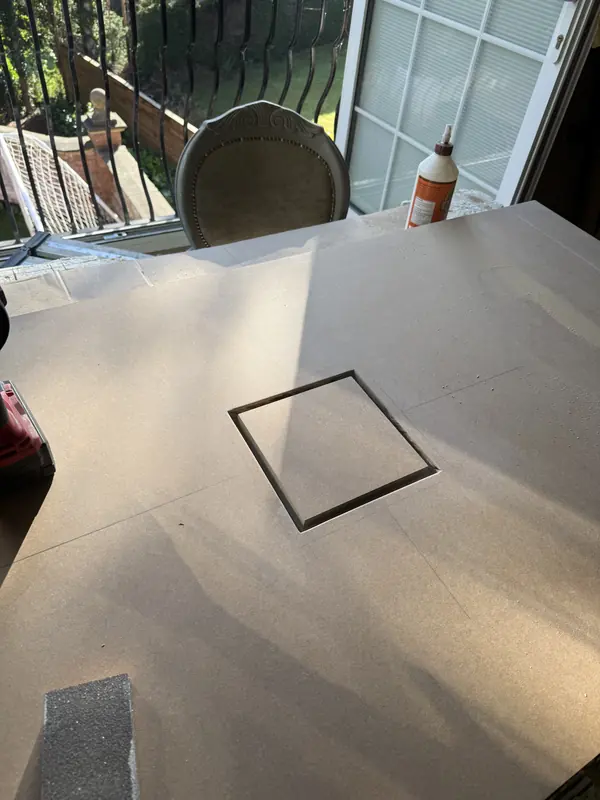 A flush access hatch routed into a ceiling board