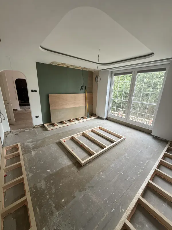 Timber framing for a raised floor platform in the master bedroom, with a curved ceiling above