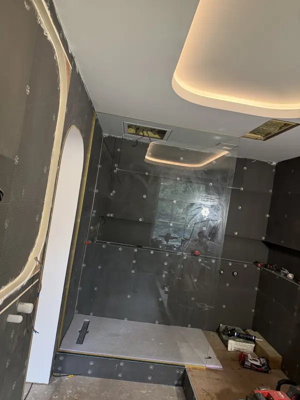 Shower enclosure under the lit ceiling coffer, before the final tiling