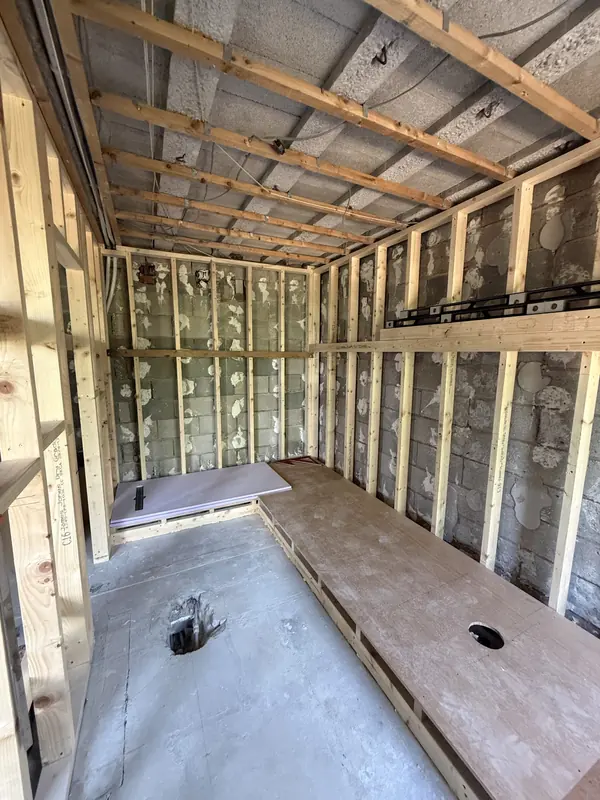 Stud framing and a raised plywood floor deck with waste outlets in the new en-suite