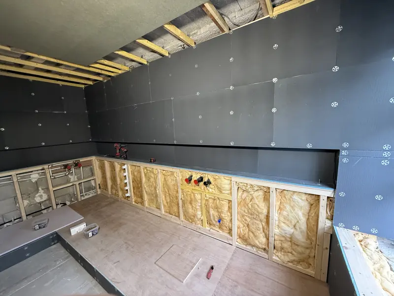 Grey tanking boards lining the en-suite above an insulated timber service void