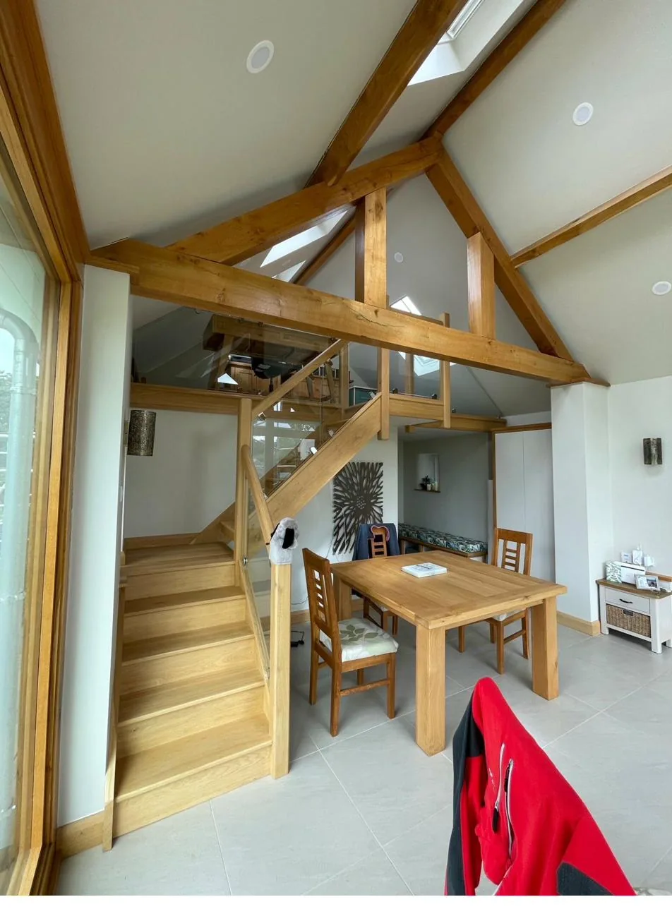 Bespoke oak staircase to mezzanine in oak timber-frame house