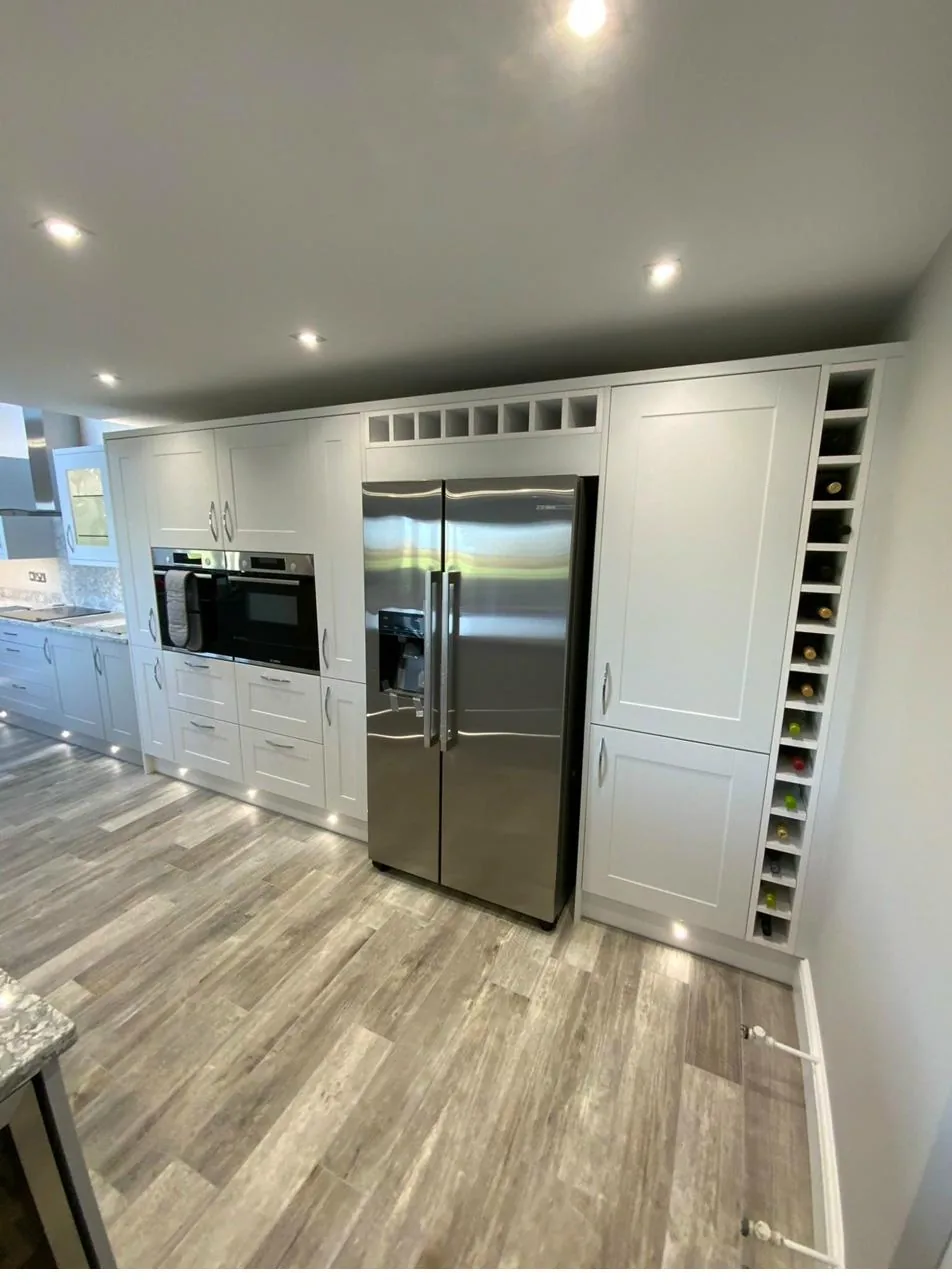 Bespoke hand-painted Shaker kitchen with integrated American fridge-freezer and slimline wine rack